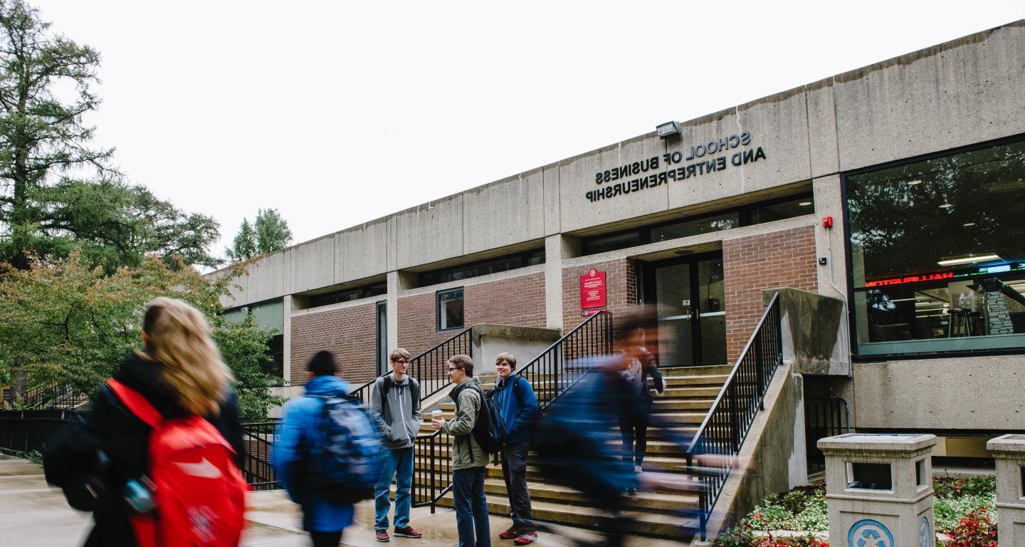 students walking passed school of business and entrepreneurship 