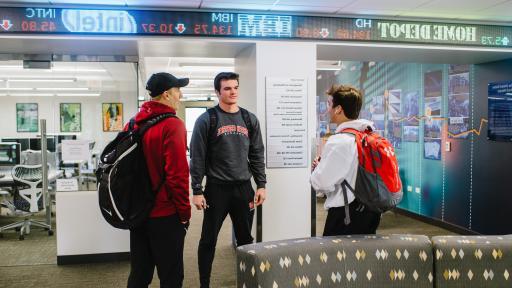 group of students talking in front of bloomberg lab 