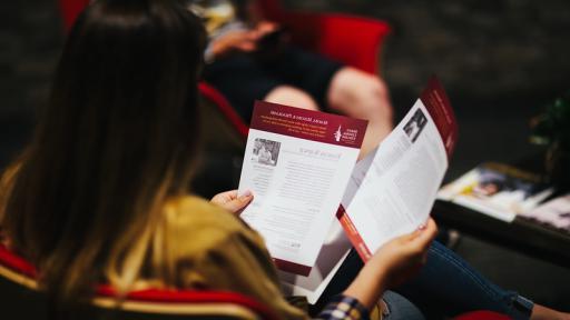 student looking at handouts